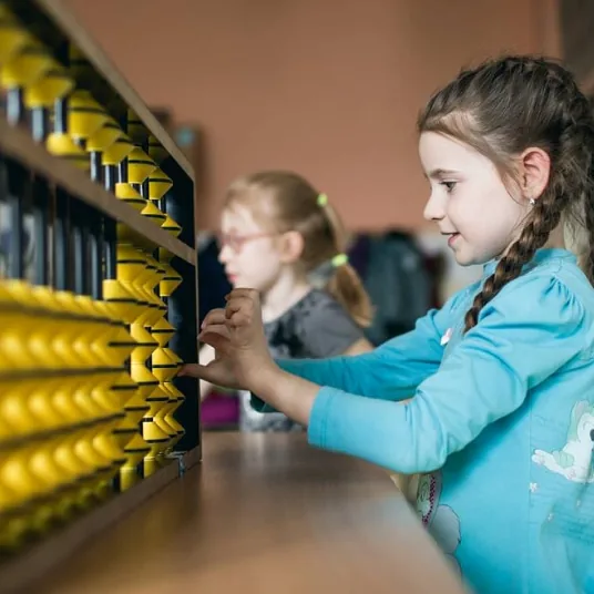 Girl working on a large classroom abacus