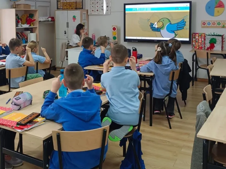Children working with abacuses in a classroom